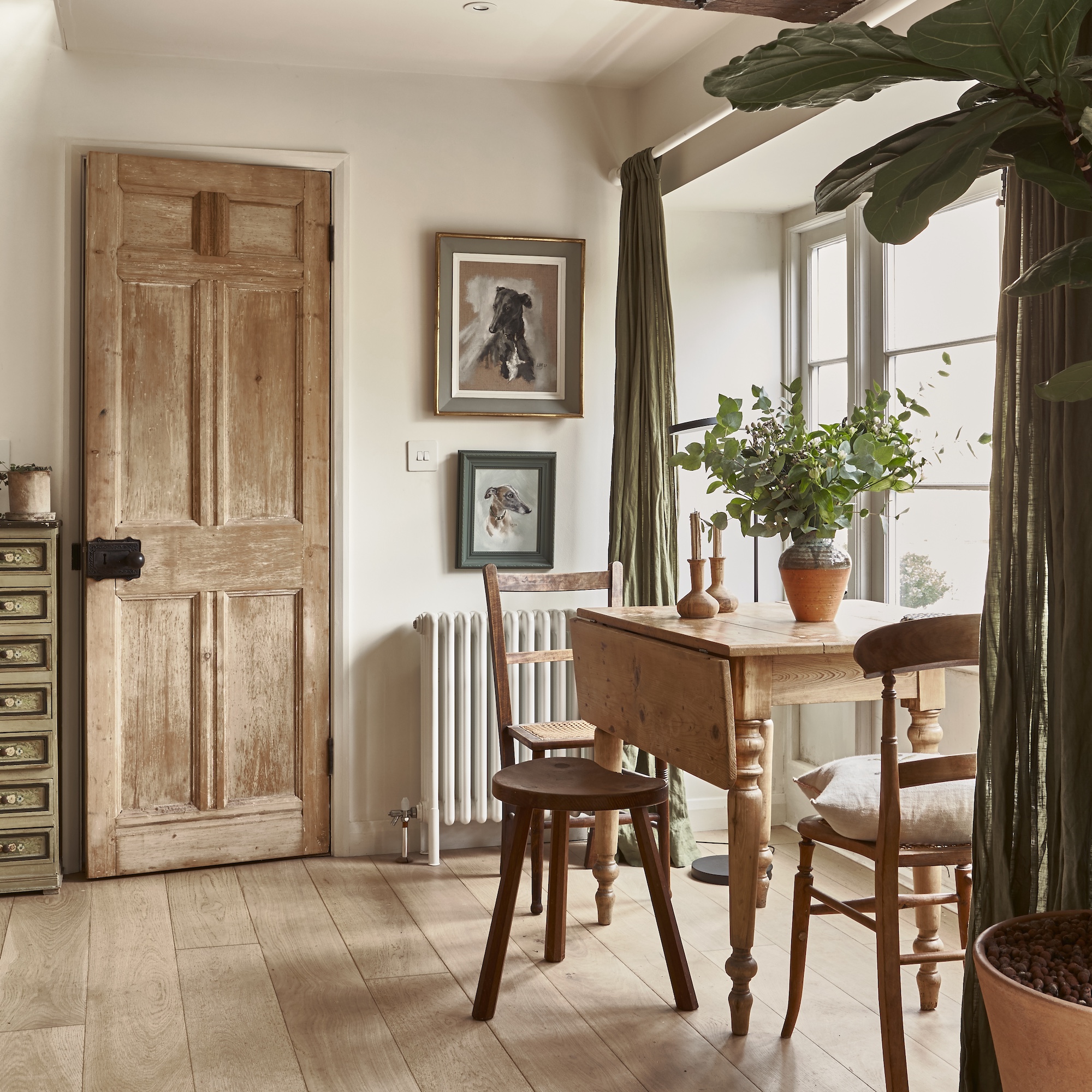 dining area with drop leaf wooden table, wooden dining chairs and small milking stool