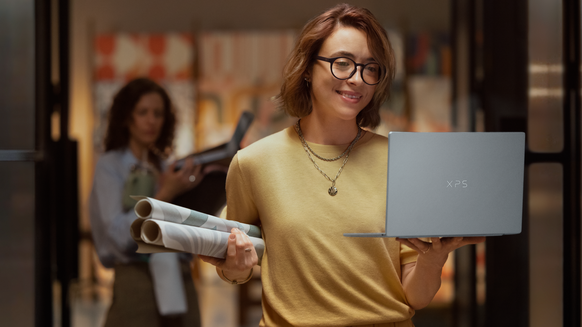 Dell XPS 13 laptop being held by a person