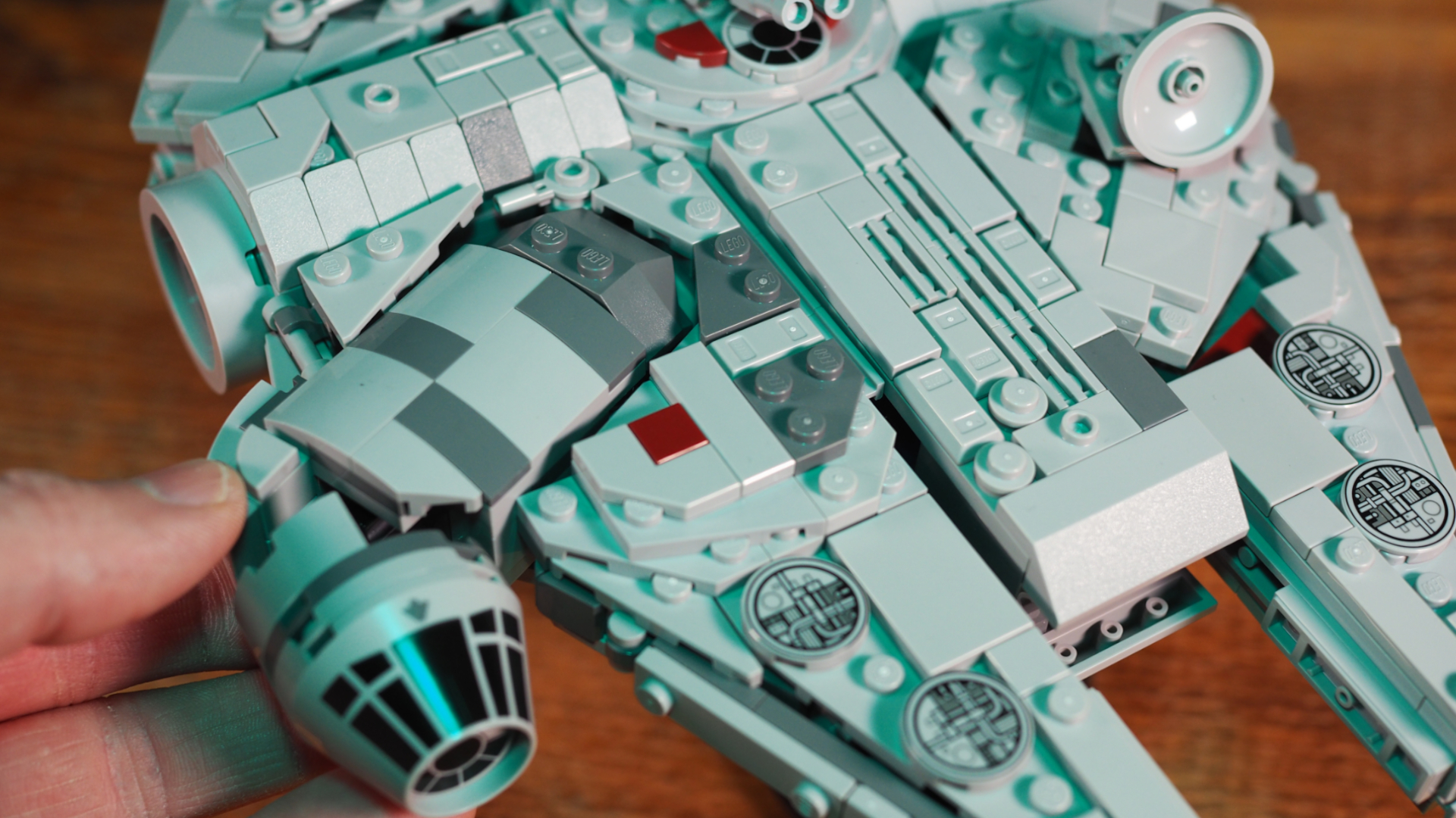 Lego Millennium Falcon set laid out on a wooden surface