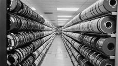 Magnetic tape storage reels secured on shelves in an electronic data storage facility, 1970s.