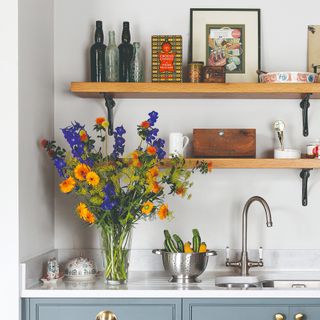 A vase of flowers on a kitchen worktop