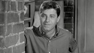 Jerry Lewis stands in a street alley in The Delicate Delinquent