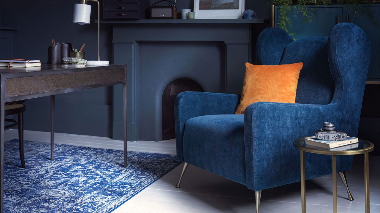 navy living room with a navy velvet armchair