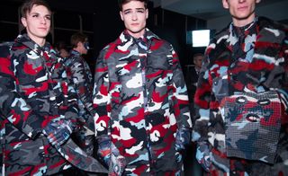 Male models wearing blue, grey, white and red camo outfits