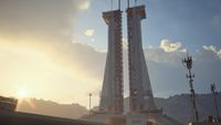 Arc Raiders Lay of the Land: A scenic shot of the launch tower on the Spaceport map as the sunsets.