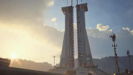 Arc Raiders Lay of the Land: A scenic shot of the launch tower on the Spaceport map as the sunsets.