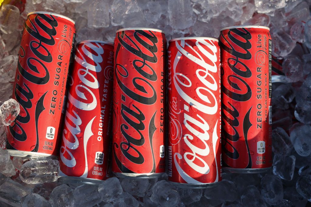 Cans of Coca-Cola and Zero Sugar Coca-Cola in ice