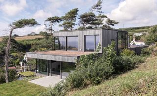 house with glass woodland and trees