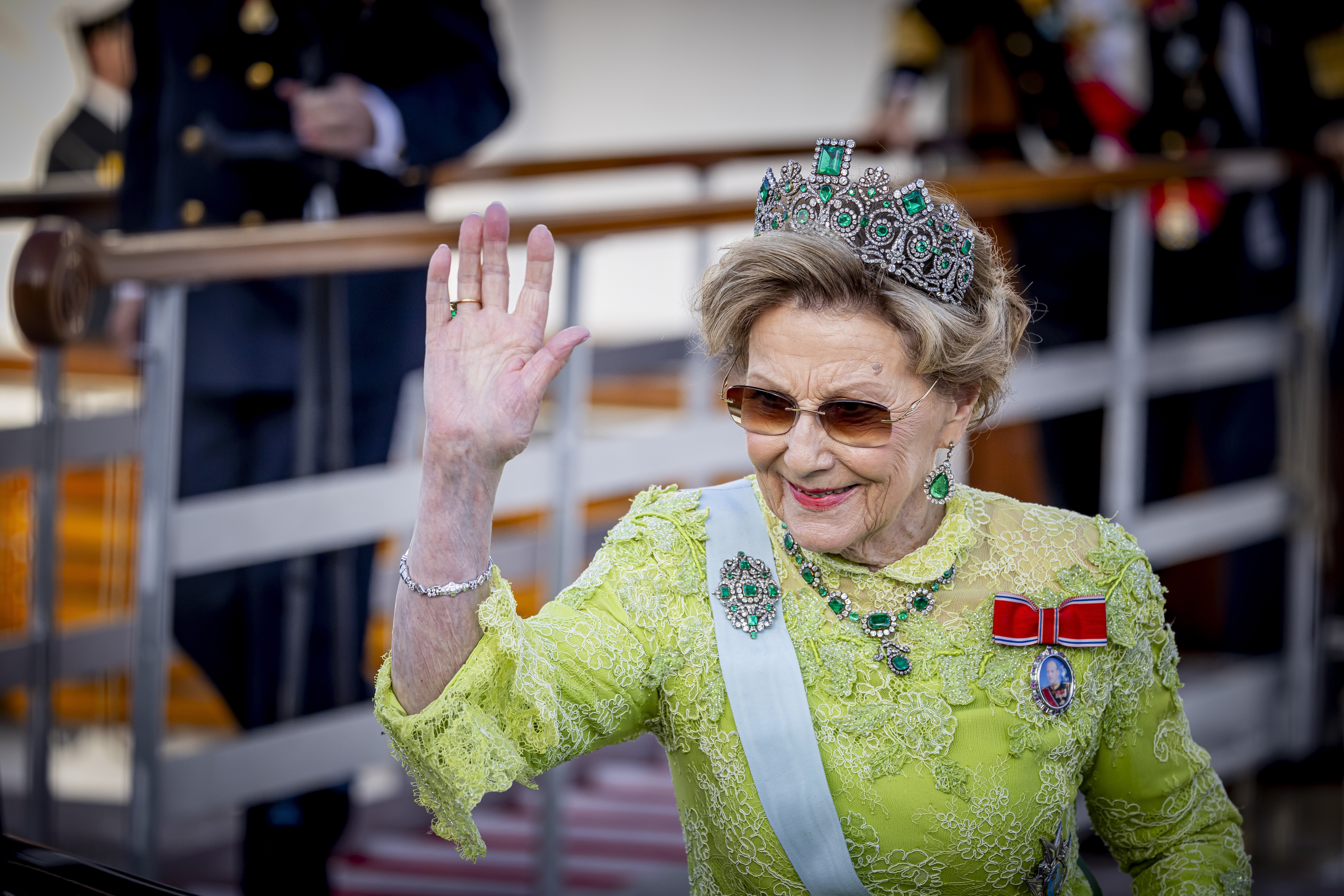 Queen Sonja of Norway waving in a green gown during the 80th Birthday celebrations of King Carl XVI Gustaf of Sweden