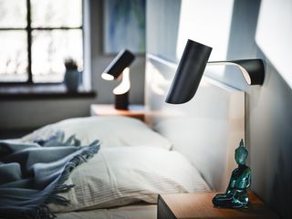 Modern black bedroom wall lights in a neutral bedroom above the bedside tables