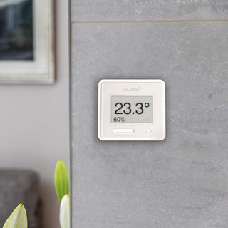 Smart thermostat on a grey wall