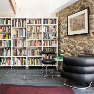 seating area with white ceiling and bookcase