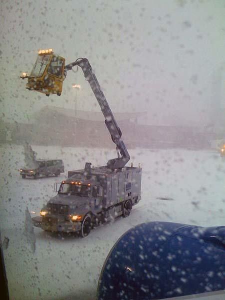 Crews de-ice the plane before Mike &amp; Mary can fly out of Boston, Massachusetts.
