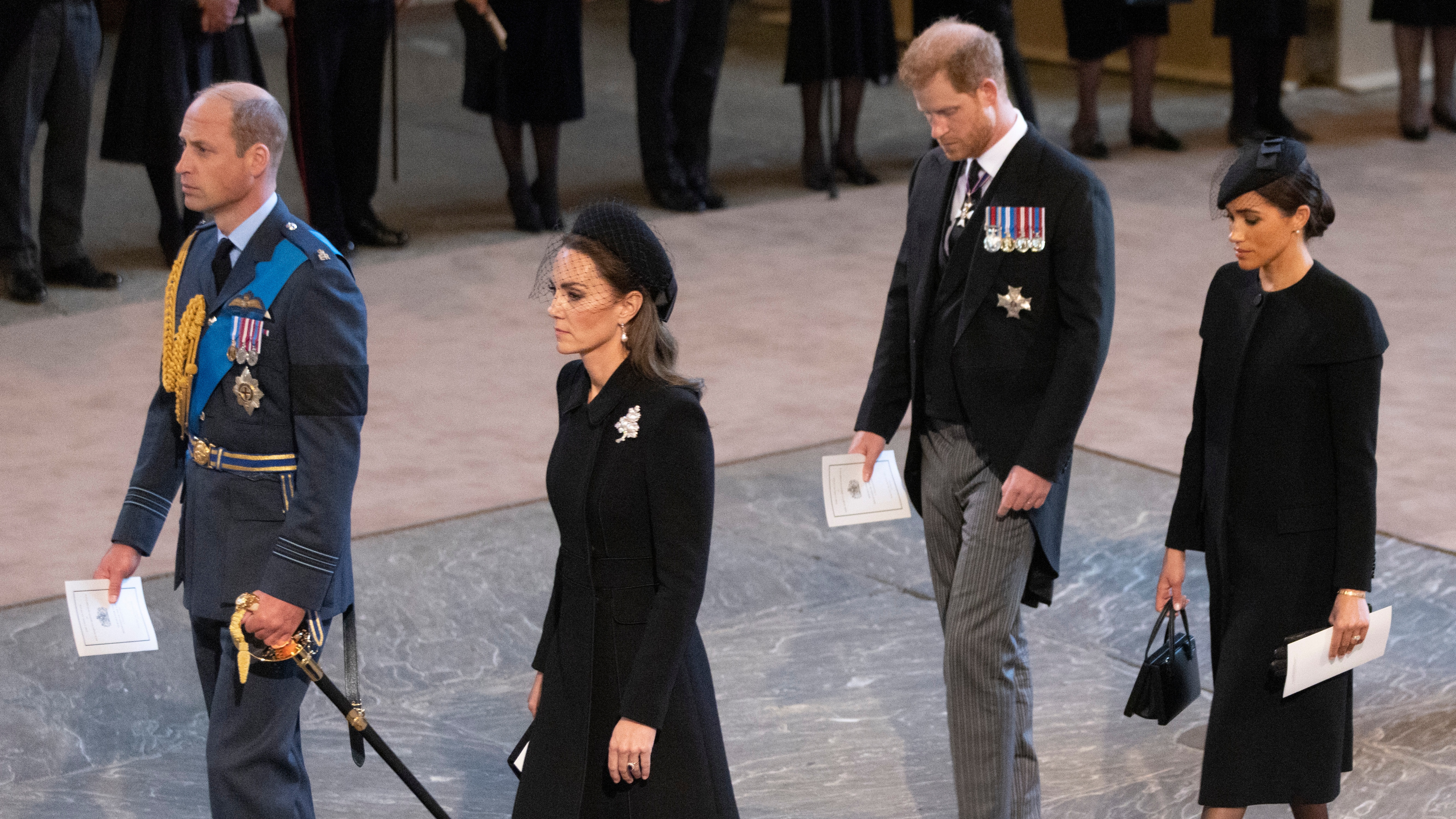 Prince William, Catherine, Princess of Wales, Harry, Duke of Sussex and Meghan, Duchess of Sussex arrive as the coffin bearing Queen Elizabeth II arrives at Westminster Hall