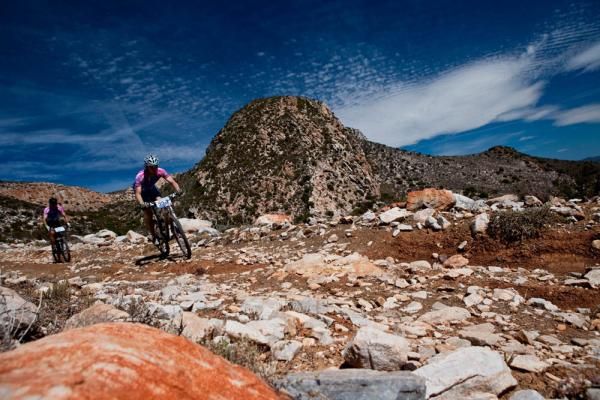 Two teammates on a rocky track