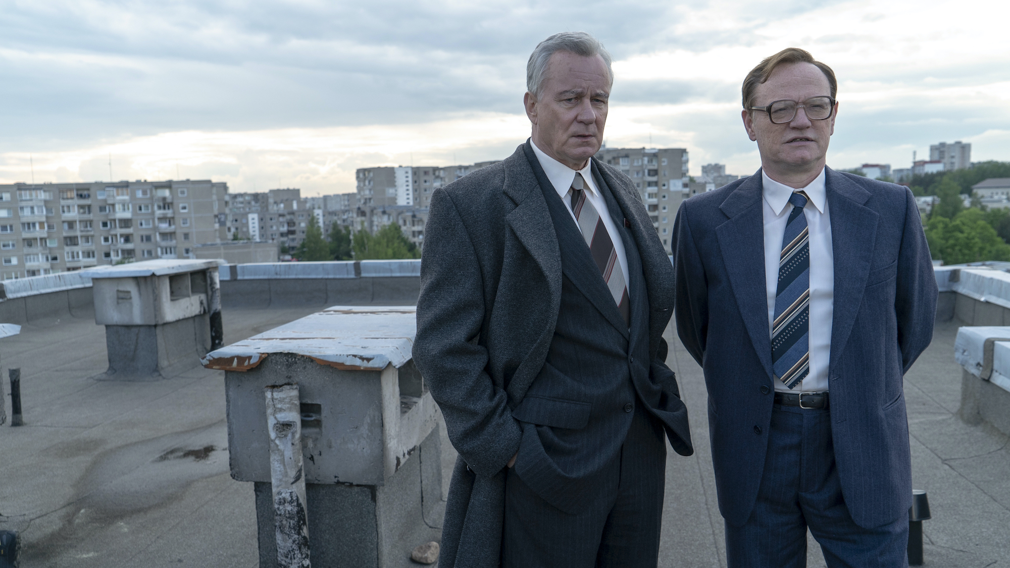 Stellan Skarsgård and Jared Harris look from a rooftop in Chernobyl