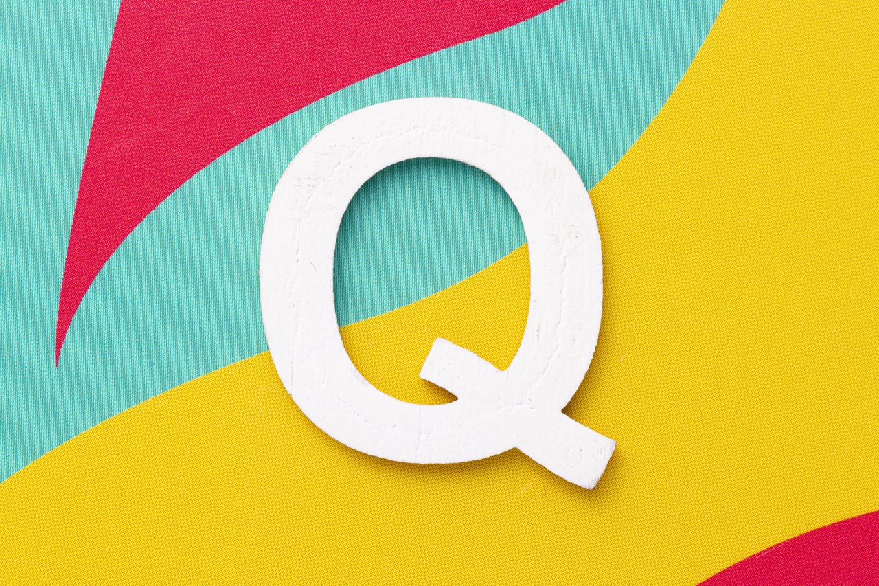 the letter &quot;Q&quot; on a colorful background of red, blue, and yellow