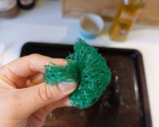 oven tray cleaning hack using mesh produce bag