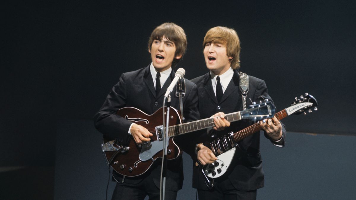 From left, George Harrison (playing a Gretsch 6119 Tennessean guitar with Bigsby vibrato) and John Lennon (playing a Rickenbacker 325 guitar) of English rock and pop group The Beatles perform together on stage for the American Broadcasting Company (ABC) music television show &#039;Shindig!&#039; at Granville Studios in Fulham, London on 3rd October 1964. The band would go on to play three songs on the show, Kansas City/Hey-Hey-Hey!, I&#039;m a Loser and Boys.