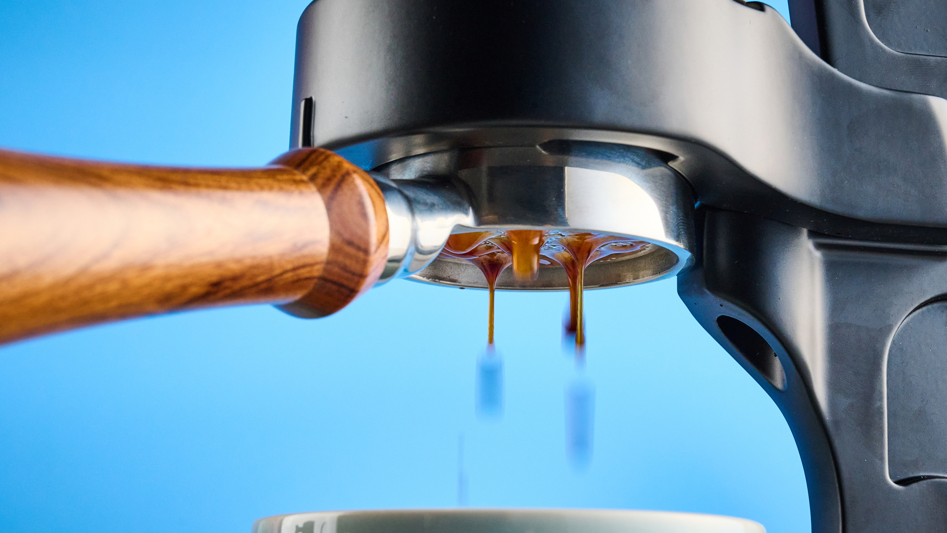 the flair 49 pro lever espresso machine photographed against the blue tom's guide background