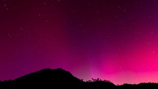 Geomagnetic storm pink sky with northern lights