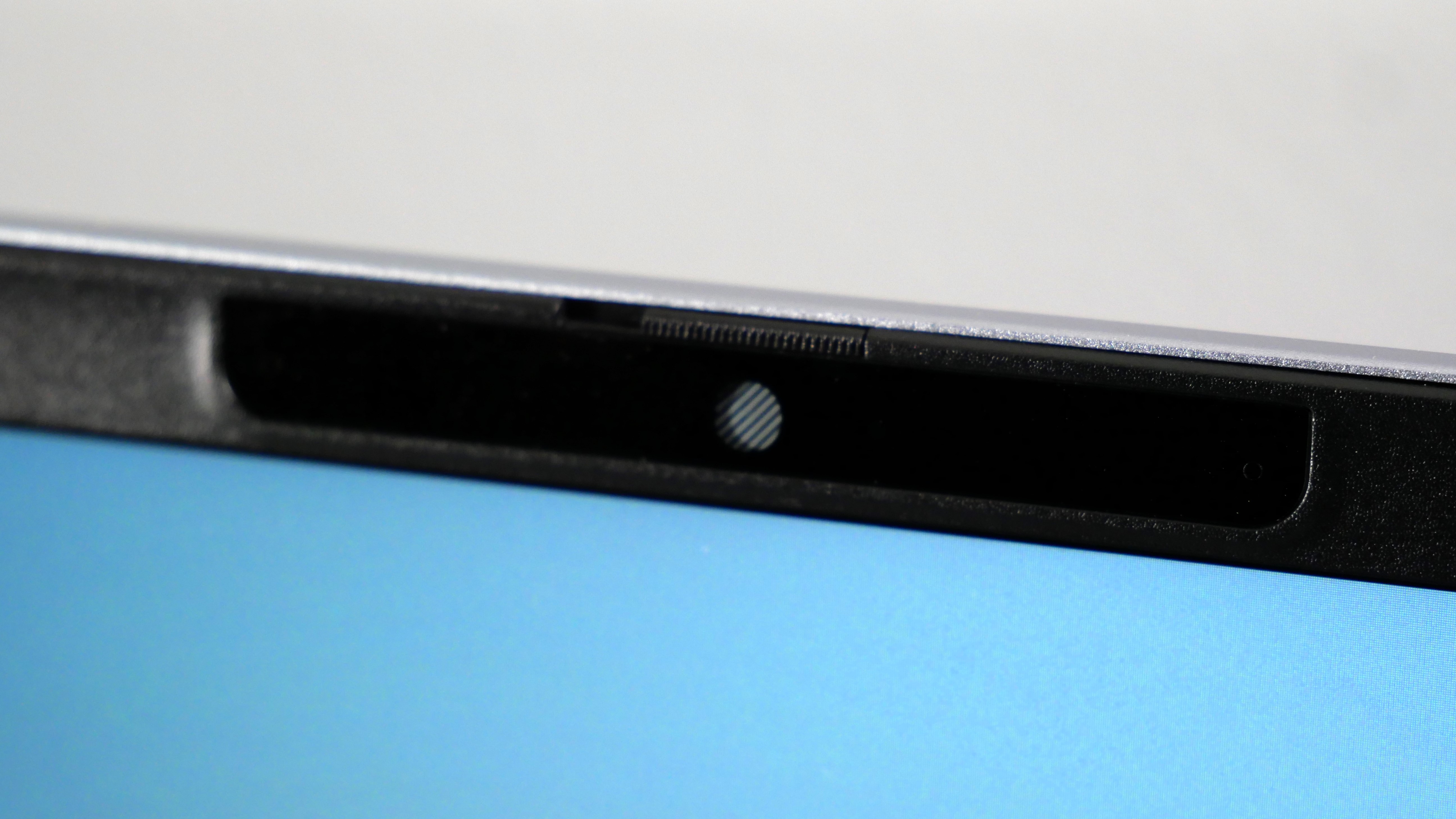 Dell 14 Plus open against a white wall, highlighting the webcam.