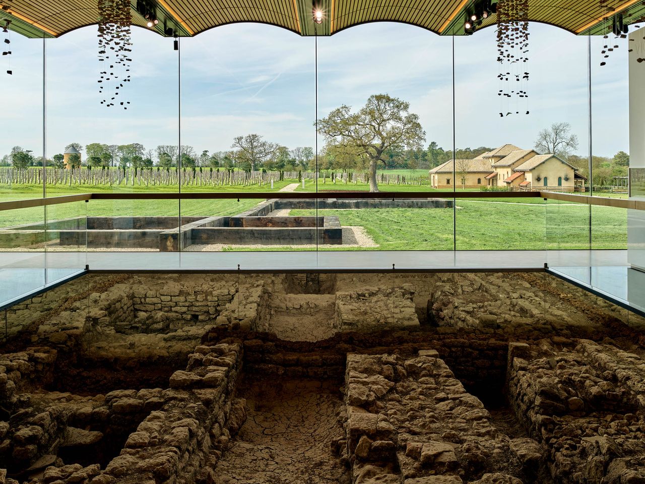 Fig 1: View over the excavated bath house in the museum towards the villa. Baulks of timber demarcate the plan of other rooms. Villa Ventorum at The Newt, Somerset. ©Paul Highnam for Country Life