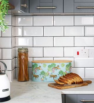 kitchen makeover with white metro tiles and white worktops