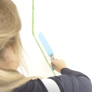 lady painting with blue paint brush