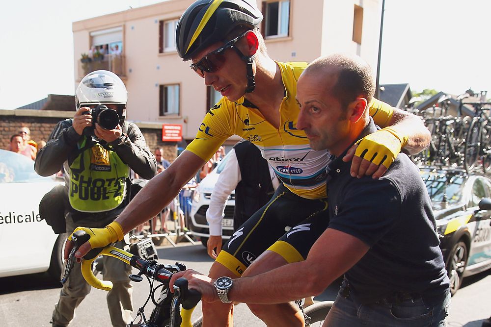 Tony Martin (Etixx-Quick Step) helped off his bike