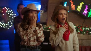 Britt Robertson as Ashley cheering in a bar during the Netflix Christmas movie, The Merry Gentlemen.