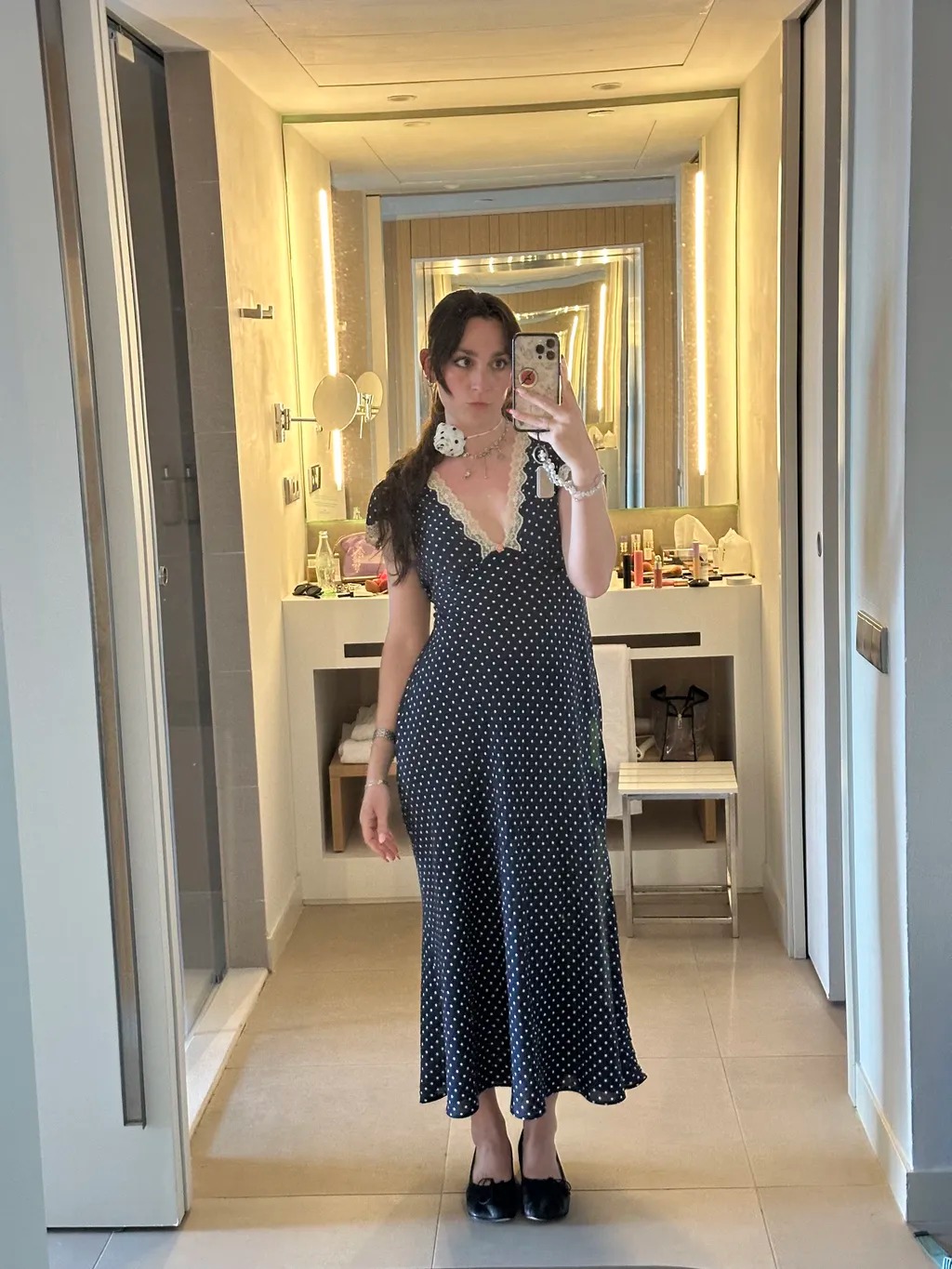Tara Gonzalez wearing a Rixo dress and taking a mirror selfie.