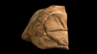 a boulder with carved marks on it