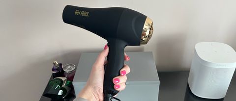 The Hot Tools Pro Signature Salon Ionic AC motor hair dryer being held in a hand