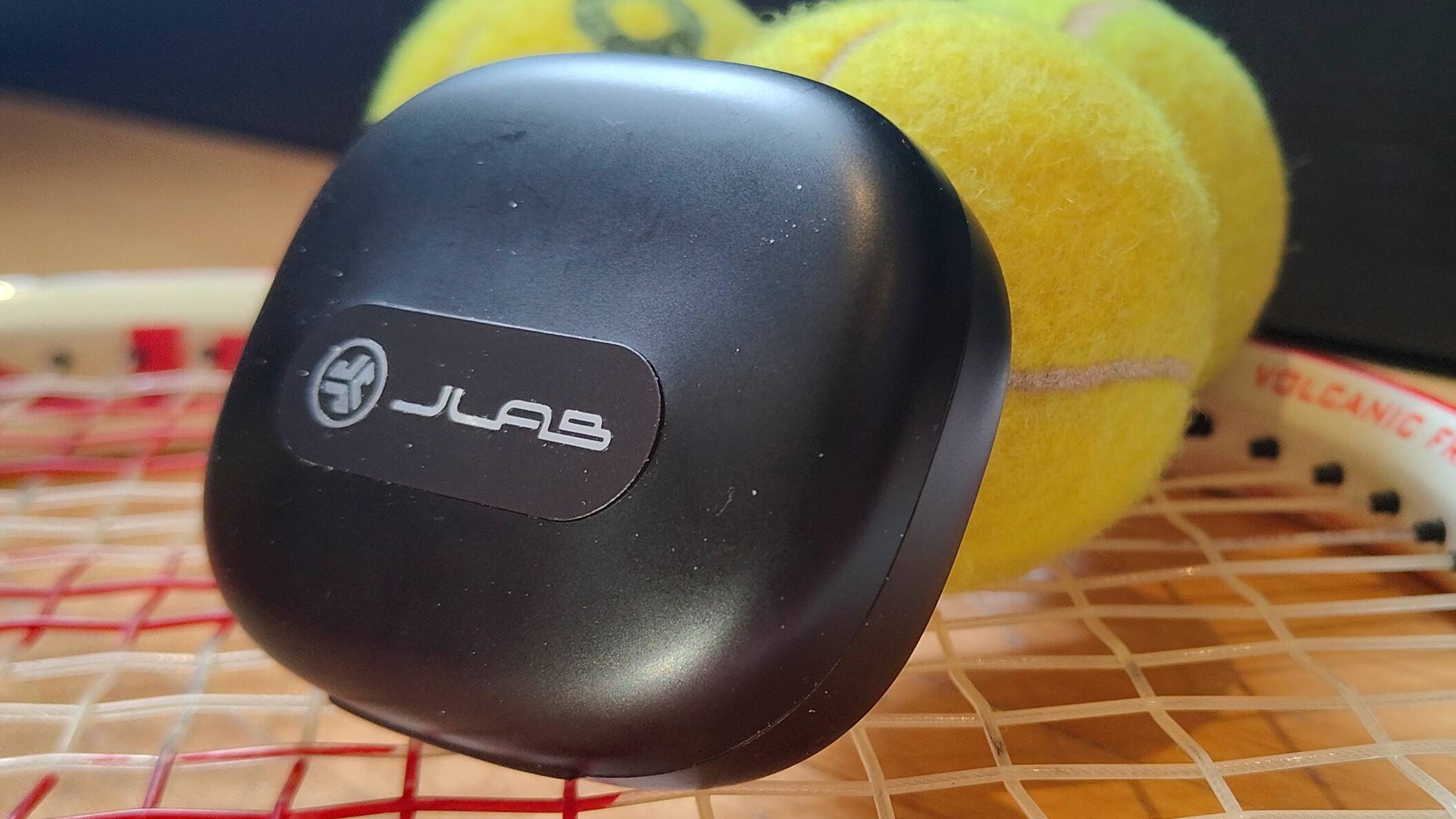 The JLab Epic Open Sport on a tennis racquet.