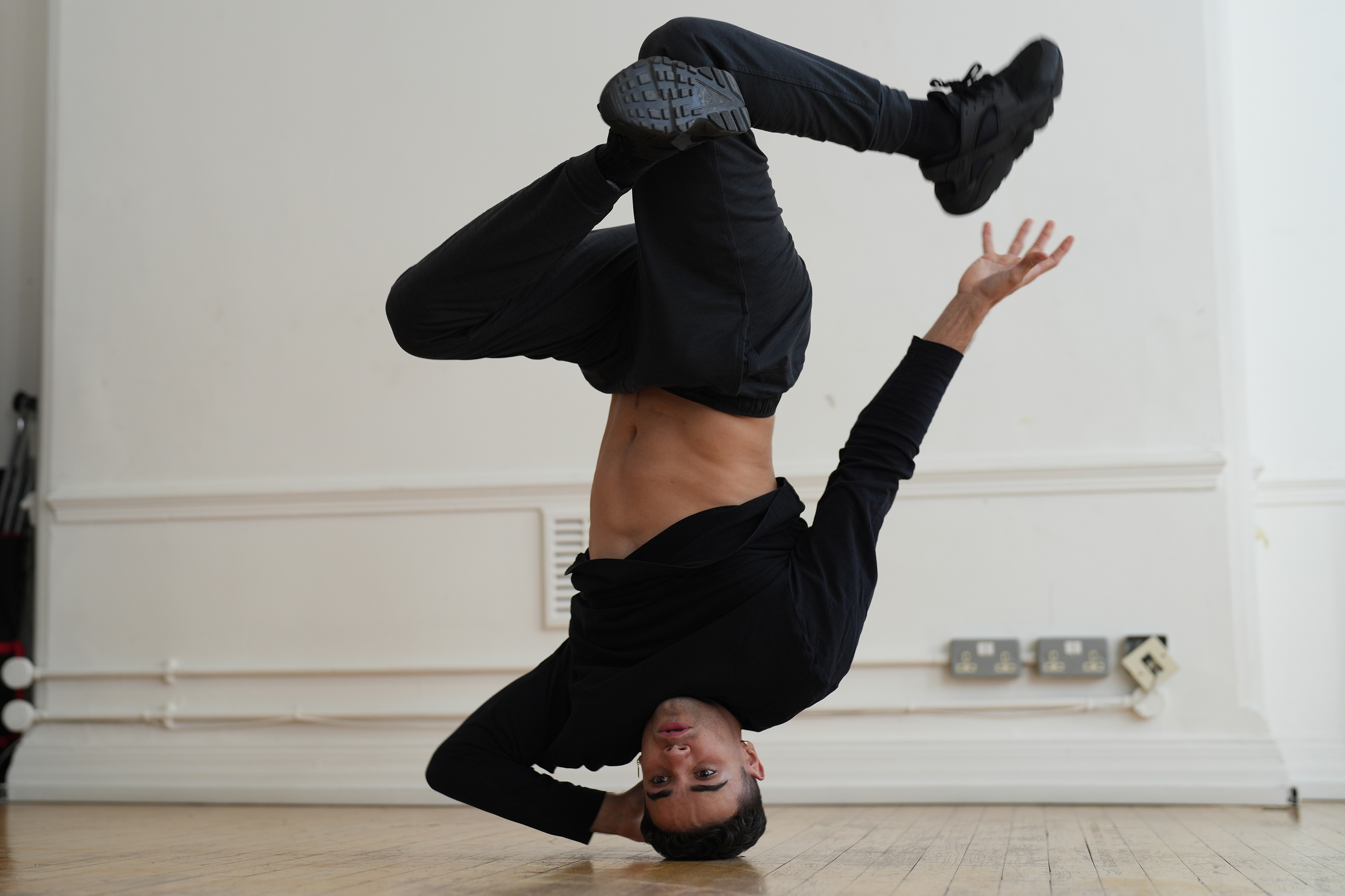 A man break dancing in a studio