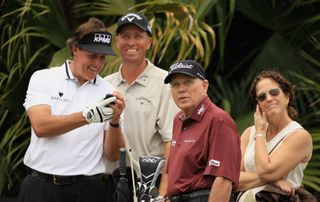 Phil Mickelson (L) waits on a tee with caddie Jim Mackay, and advisors Butch Harmon and Julie Elion during final practice round prior to the start of the World Golf Championships-Cadillac Championship on the TPC Blue Monster at Doral Golf Resort And Spa on March 7, 2012