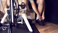 a photo of a man sat by a turbo trainer