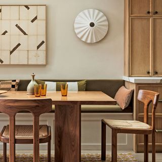 White dining room with structural light and brown furniture