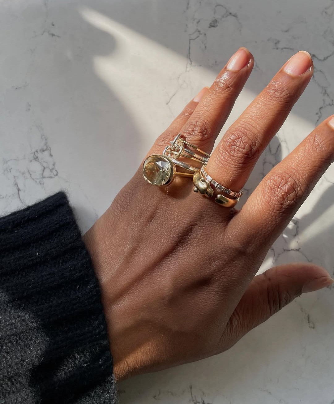 An image of @chiarasatelier wearing a yellow diamond engagement ring.