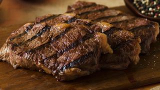 Grilled steak on a wooden chopping board