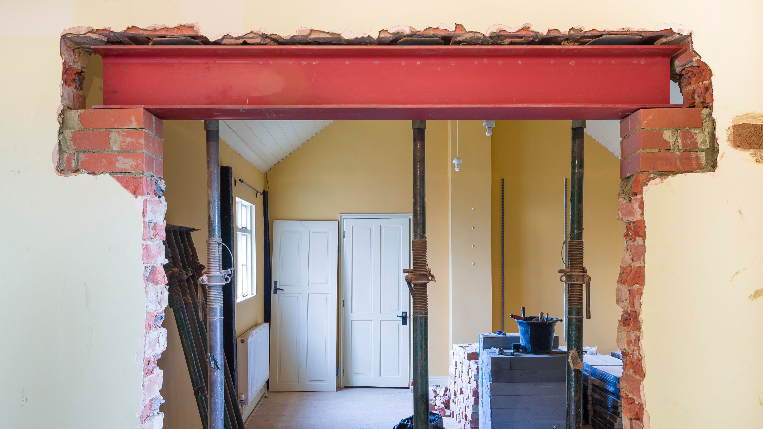 Knocking down walls during a renovation project, with acrow props supporting the RSJ as it&#039;s installed