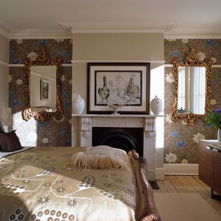 bedroom with wallpaper wall and firepalce and mirror and wooden floor
