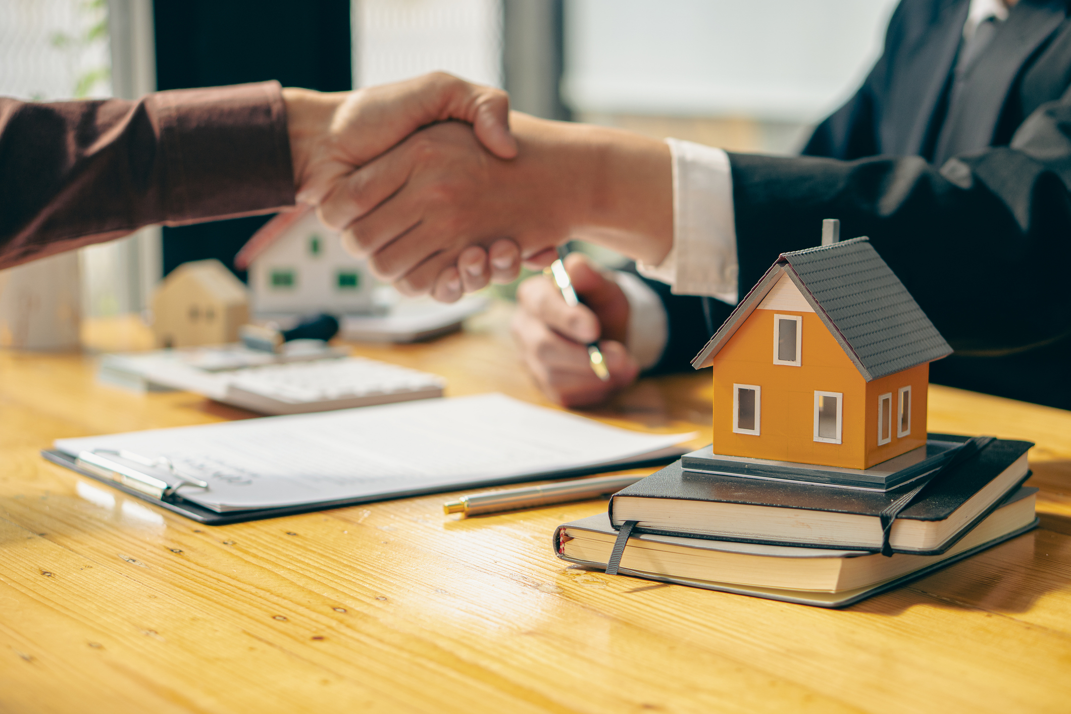 Shaking hands closely with the real estate agent in the office