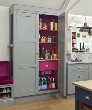 kitchen cupboard with door open and pink interior