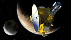 a rectangular spacecraft wrapped in metallic foil with a large, round communications dish floats in the blackness of space near a white, icy-looking planet