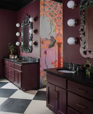 A bathroom with burgundy walls and a pink wallpaper
