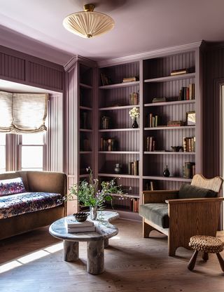 purple living room with sheer drapes at the window