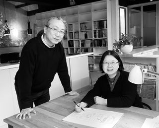 Dong Mei and Liu Xiaochuan of BCKJ Architects sat at a table with a drawing