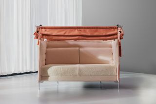 A two-seater 'Alcove' sofa in pale pink and orange tones.